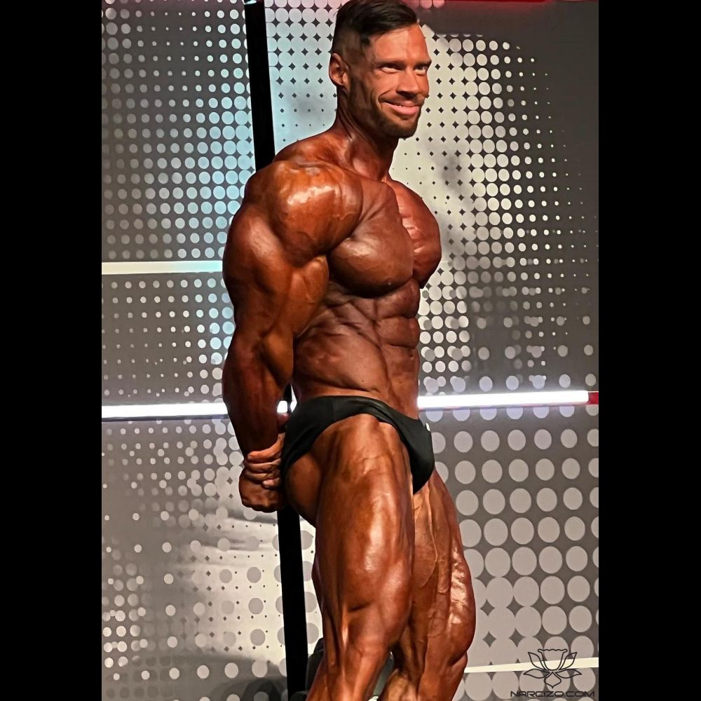 NPC Classic Physique Ken Rogers runs through his posing routine at the NPC  Photo gym. - NPC News Online